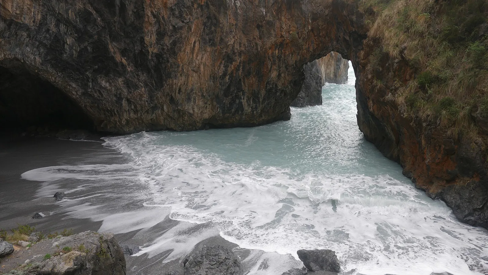 Arcomagno beach with a natural rock arch.