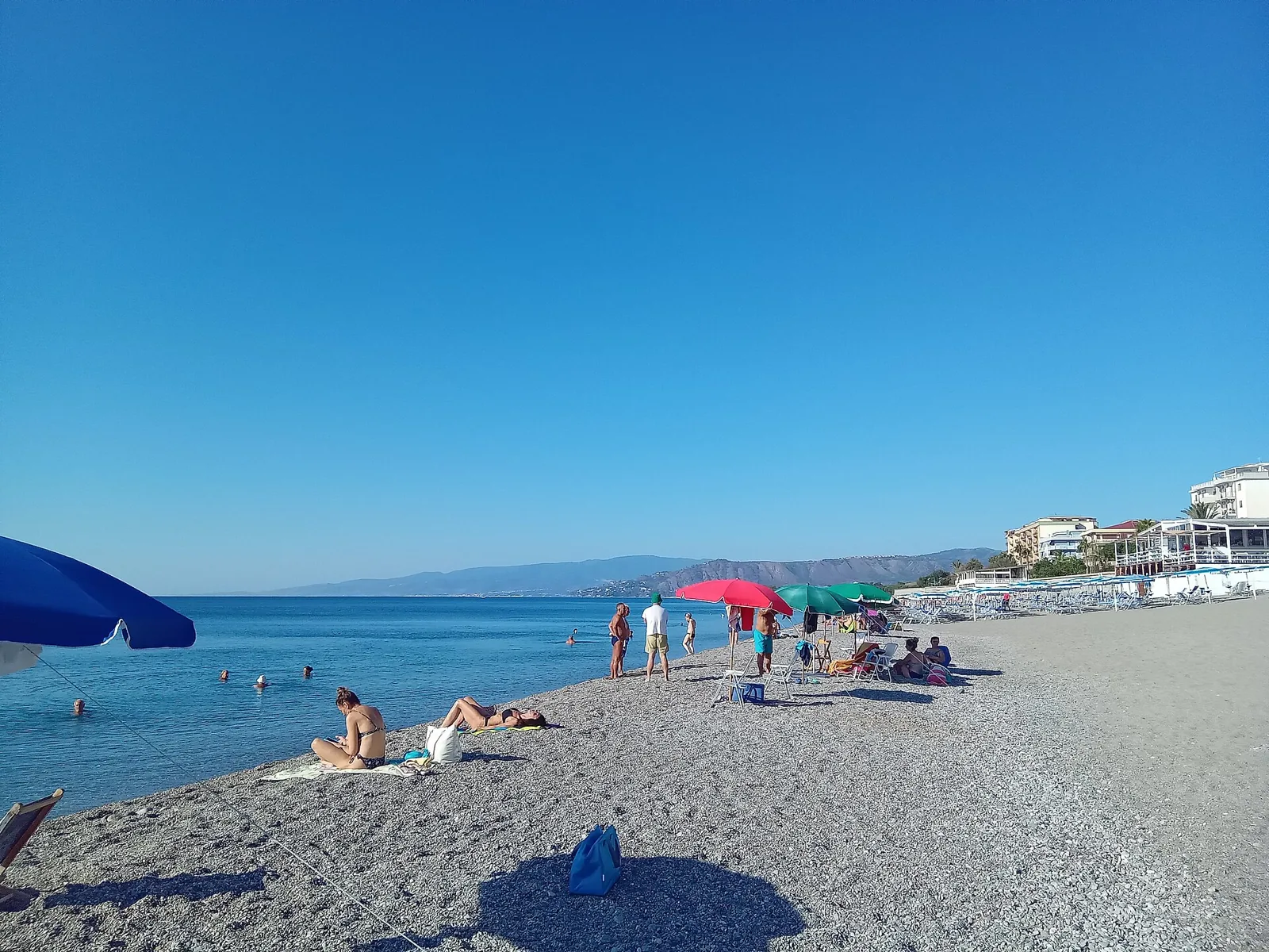 Catanzaro Lido beach with umbrellas and waterfront buildings
