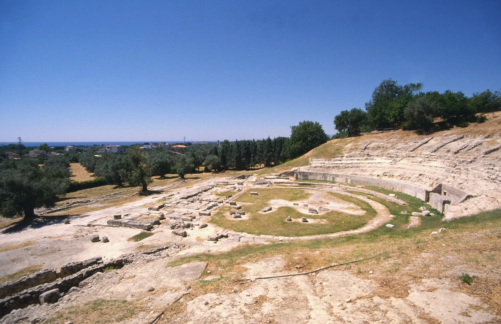 Ruins of the Locri Epizefiri theater above the coast.