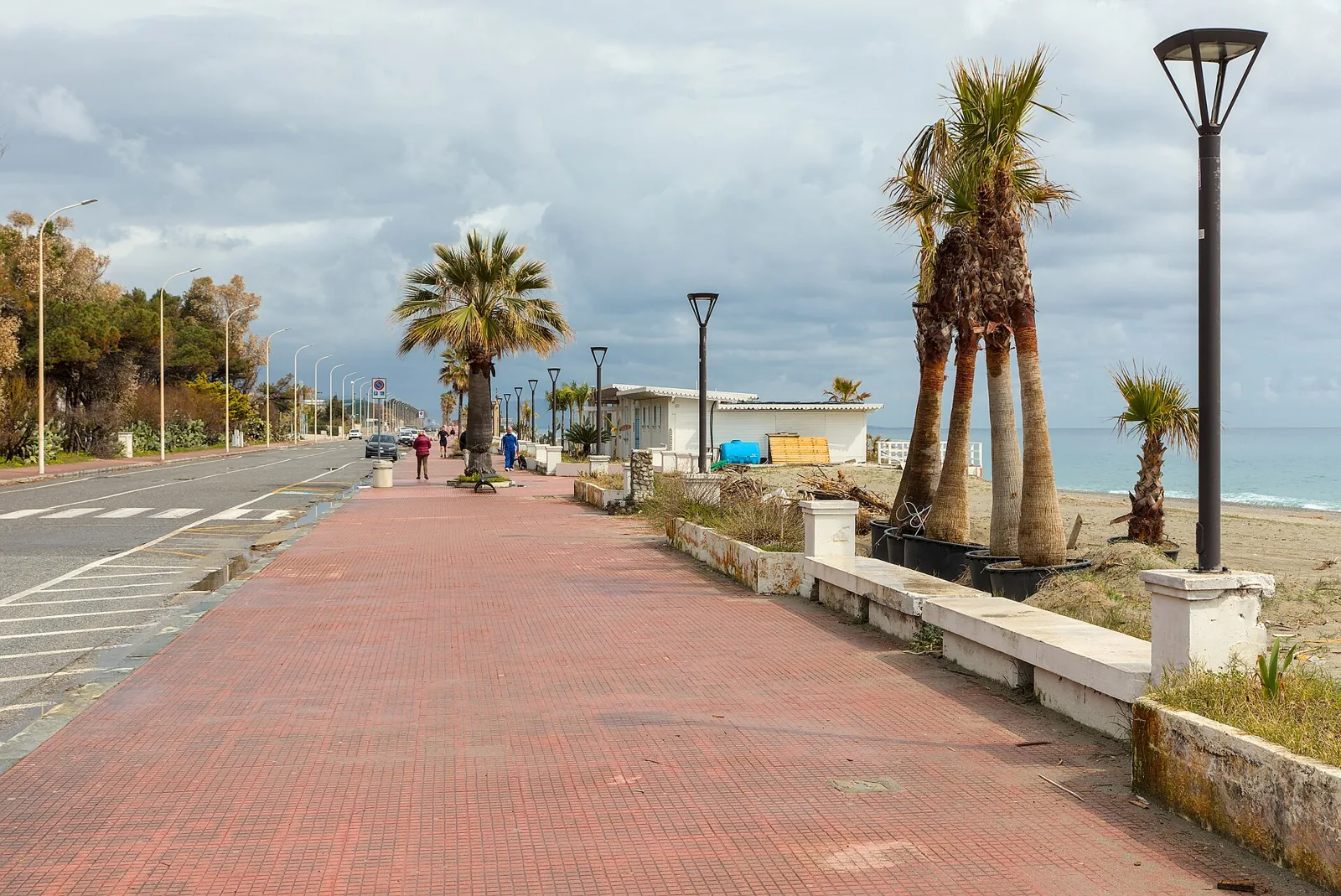 Seafront promenade in Locri with palms and sea