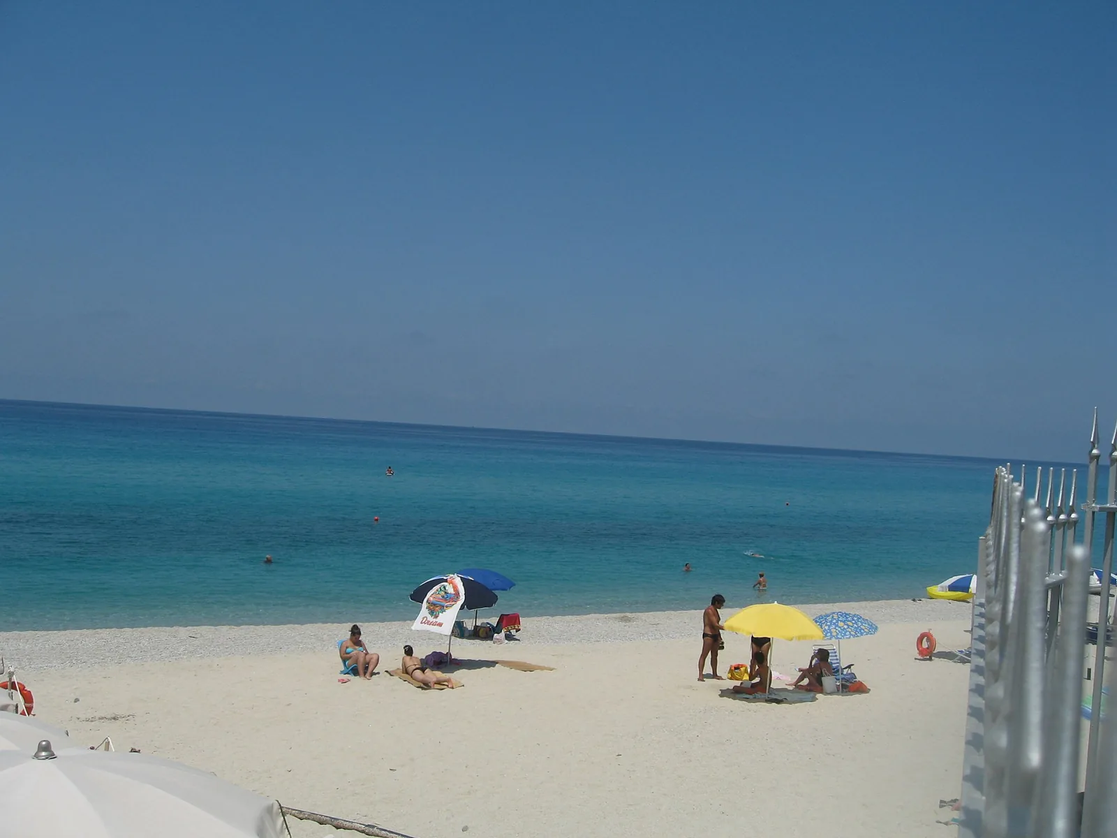Zambrone marina beach with pale sand and umbrellas