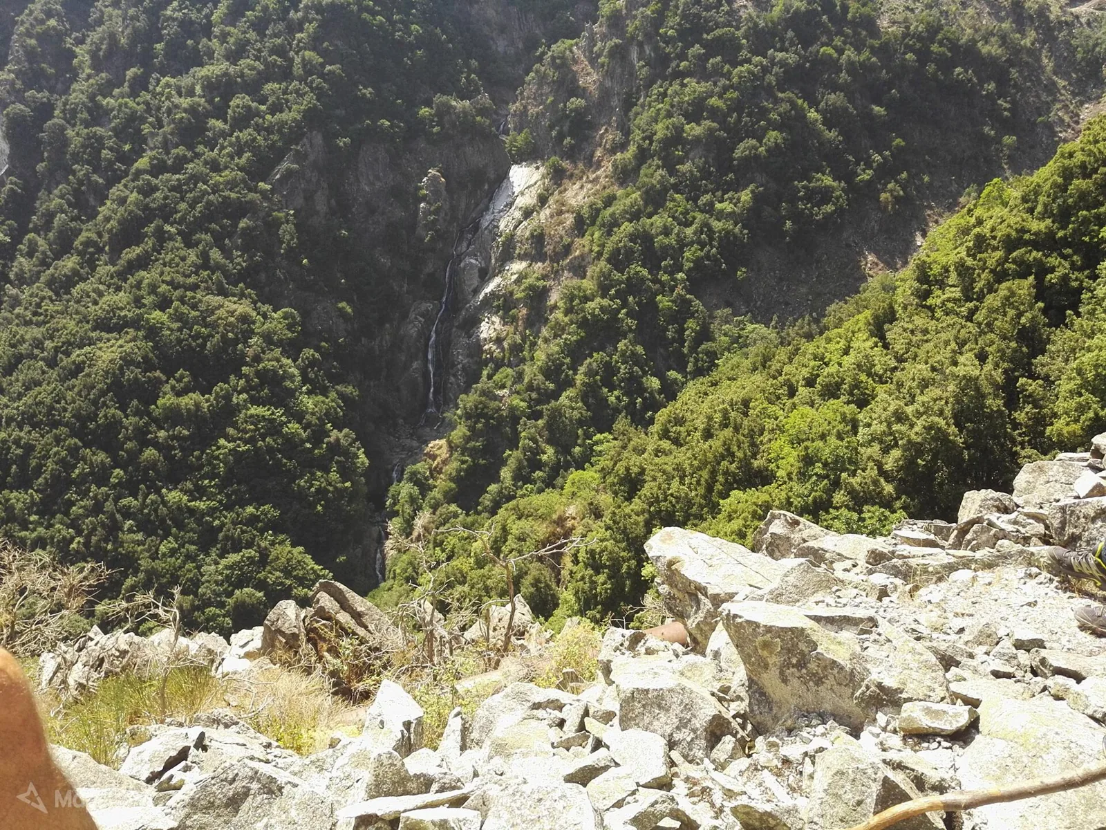 Marmarico waterfall drops in a green gorge.