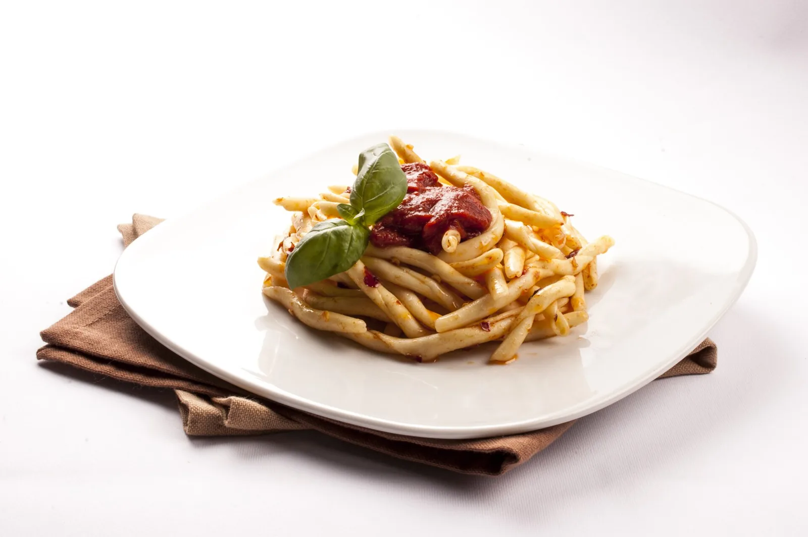 Fileja with nduja on a white plate in Calabria