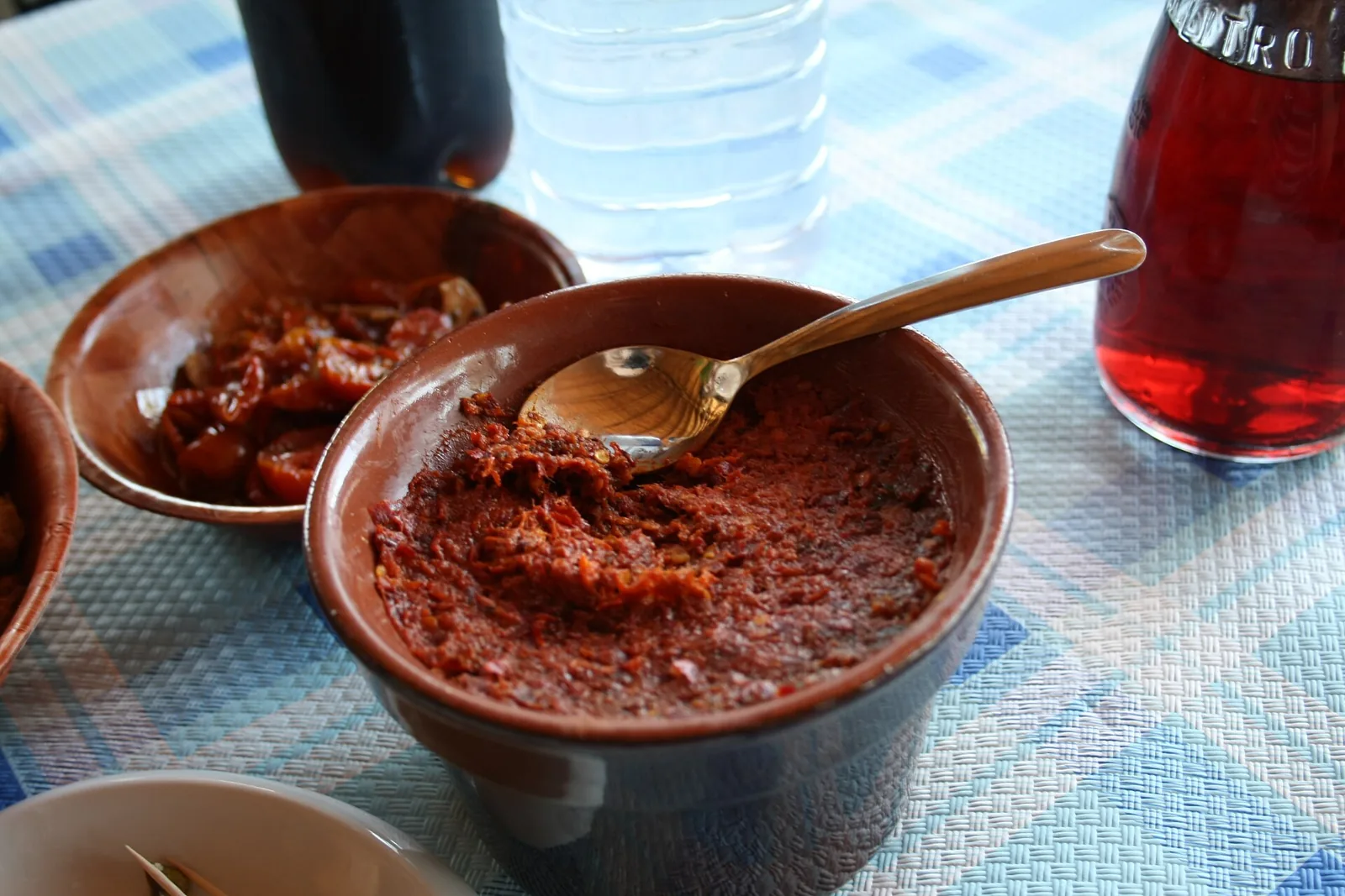 'Nduja in bowl with spoon and bread