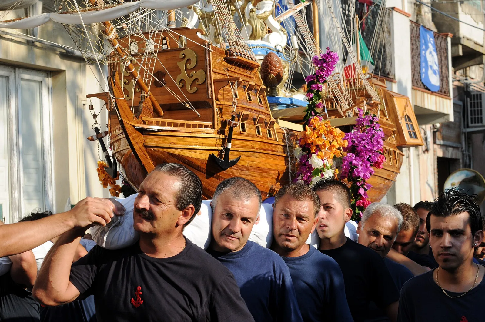 Men carry the wooden ship of Varia di Palmi.