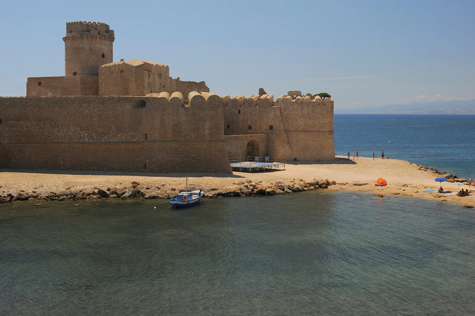 Le Castella fortress by sandy beach and sea