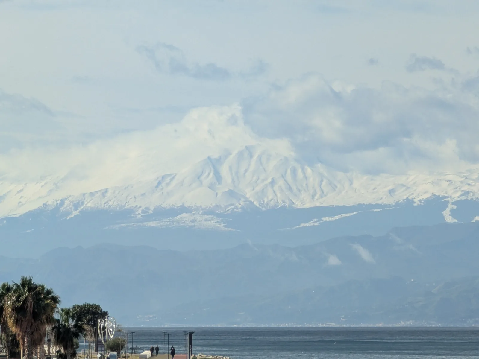 Snow-capped Mount Etna seen from Reggio Calabria across the Strait of Messina